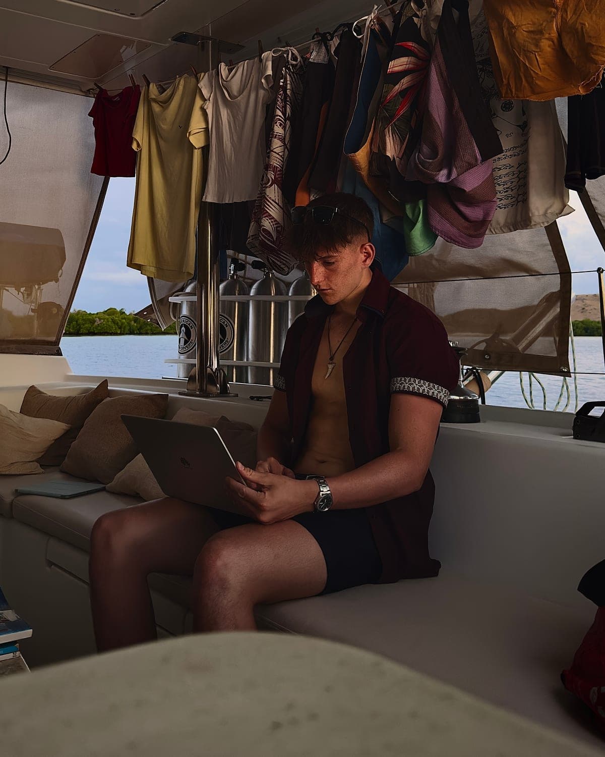 Zac working on a laptop on a boat in Bali